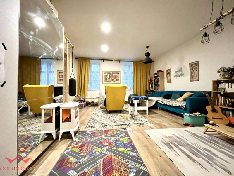 Living room in a family house with a wooden decor floor, details of toys and furniture.