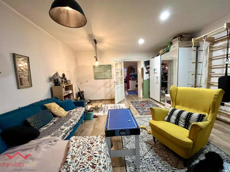 Living room in a family house with colorful furniture and a wooden decor floor.