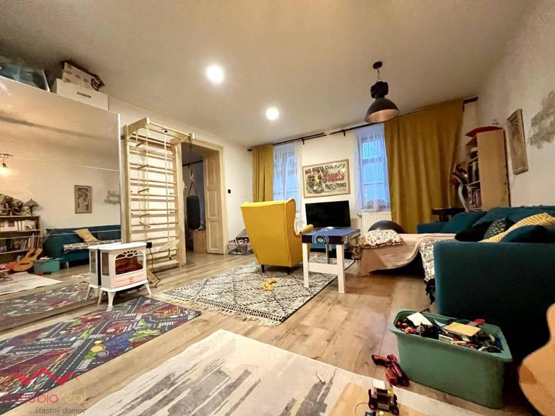 Living room in a family house with a wooden decor floor and various decorations.