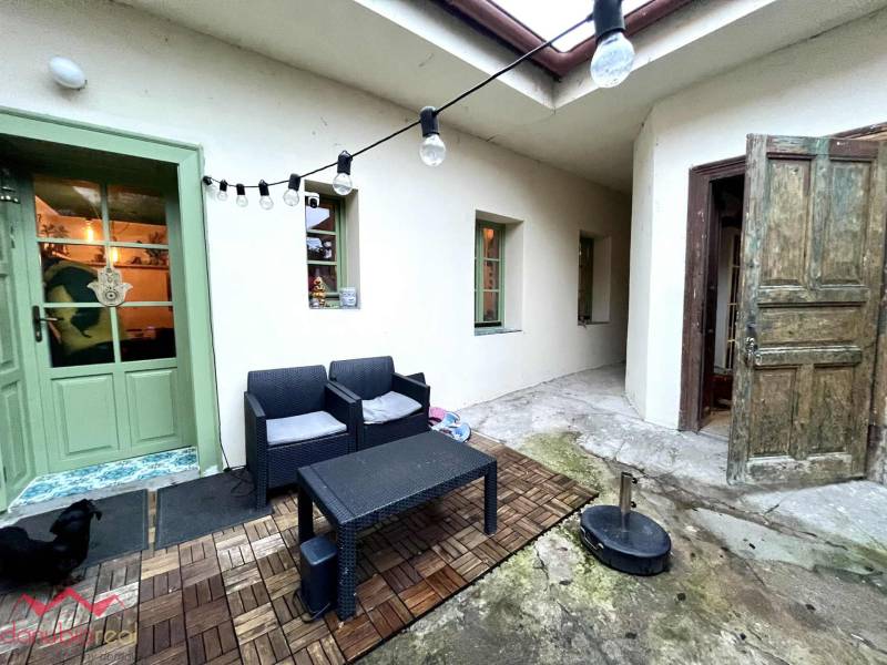 Entrance to the terrace of a family house in Komárno with garden furniture and lighting.