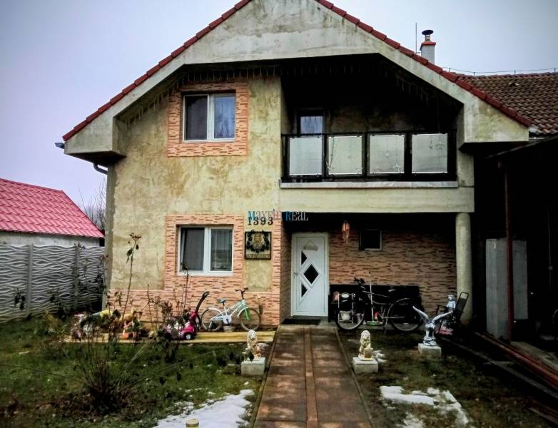 Family house on Hlavná Street in Vlčany, with a bicycle and a motorcycle in front of the entrance.