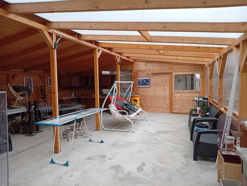 Interior of a family house with wooden construction, furniture, and a clothes drying rack.