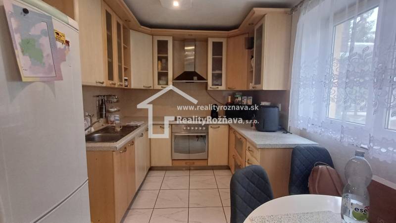 A kitchen in a 2-room apartment with corner cabinets and a spacious countertop.