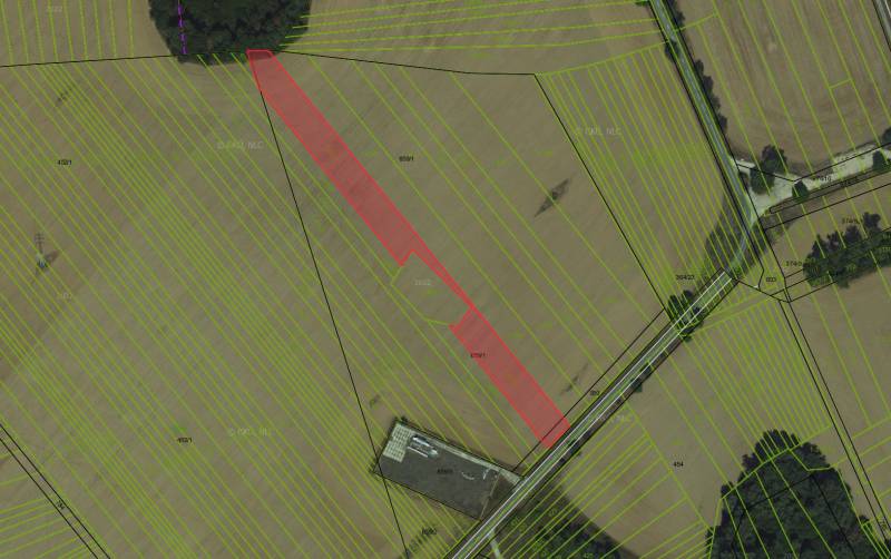Aerial view of agricultural and forest lands in Ižkovce with marked parcels.