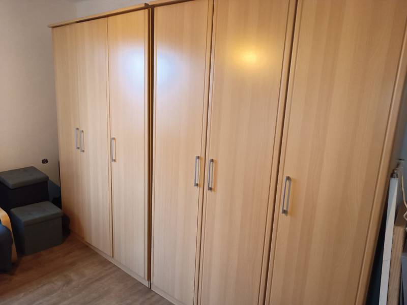Storage cabinets in a family house, with a wooden decor floor.