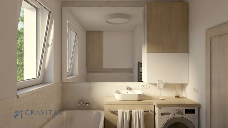 A bathroom in a 2-room apartment with a window, a bathtub, a washing machine, and cabinets with a wooden decor.
