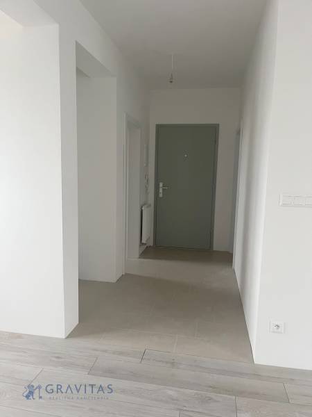 Interior of a 2-room apartment with a wooden decor floor and entrance door.