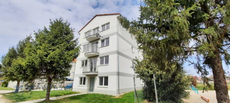 An apartment building on Školská Street in Chorvátsky Grob surrounded by greenery.