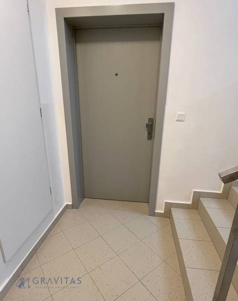 Entrance door of a 2-room apartment with a staircase and tiles.