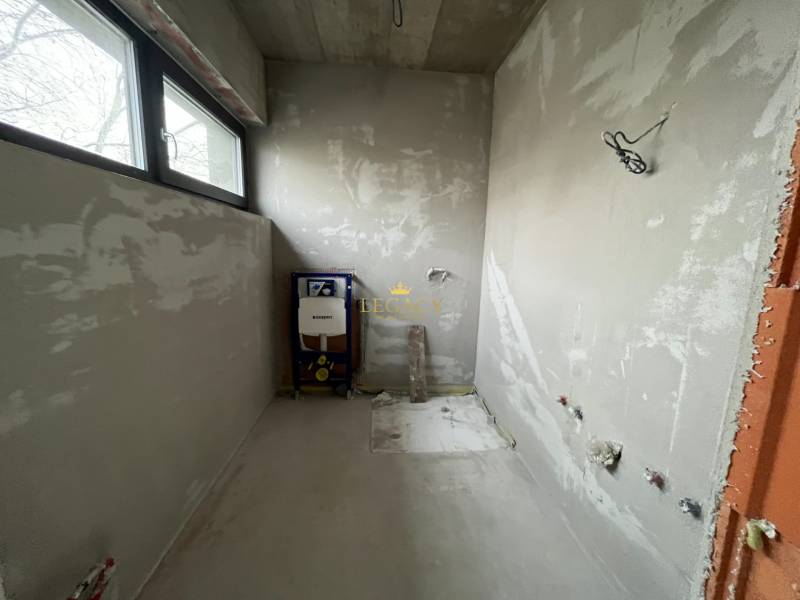 Unfinished bathroom in a family house with a view through the window.