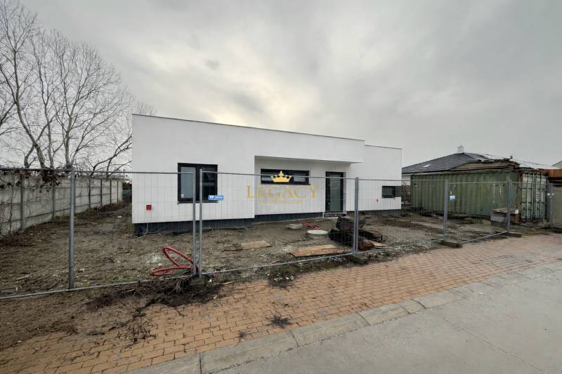 Family house on Sokolia Street in Chorvátsky Grob, being completed, with a fence and building materials.