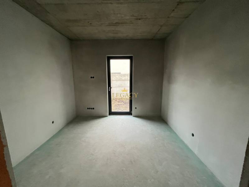 An unfinished room with unplastered walls and a concrete ceiling in a family house.