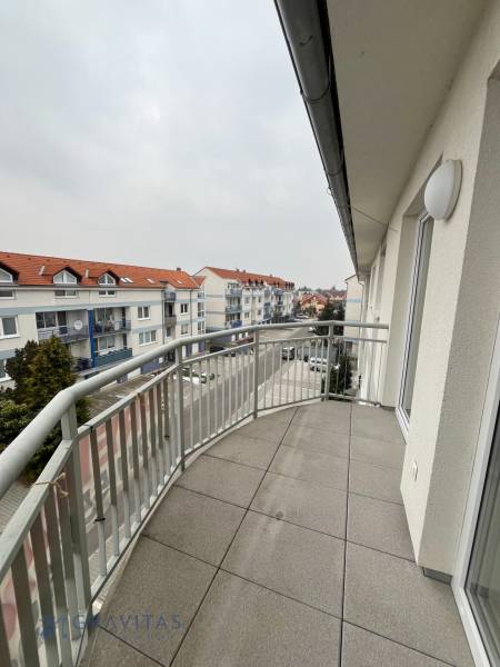 Balcony of a 3-room apartment on Školská Street in Chorvátsky Grob with a view of the surroundings.