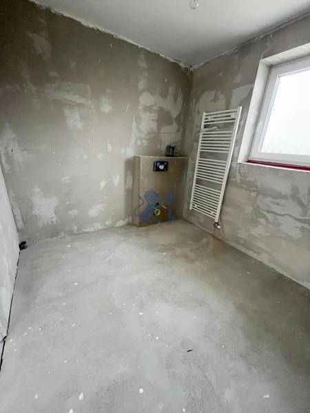 An unfurnished room in a 3-room apartment with plastered walls and a radiator.