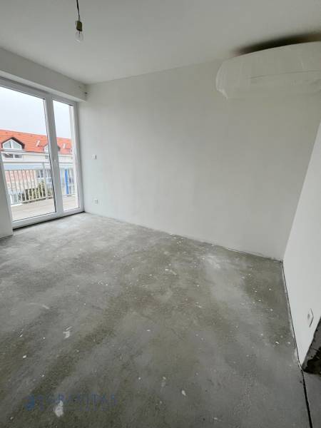 An empty room in a 3-room apartment with access to a balcony, Školská Street.