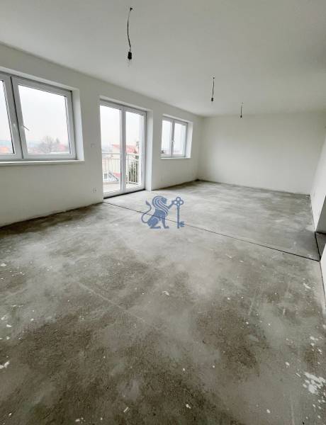 A spacious room in a 3-room apartment with a concrete floor and large windows.
