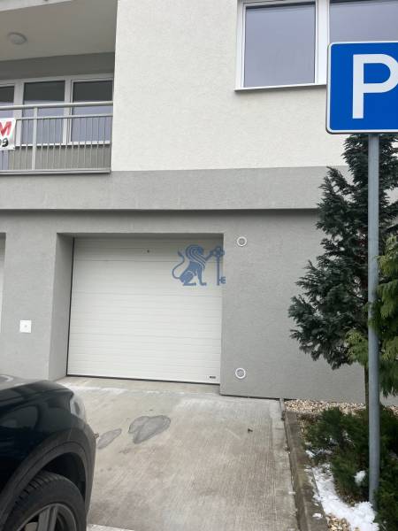 The facade of the building on Školská Street in Chorvátsky Grob with an entrance garage.