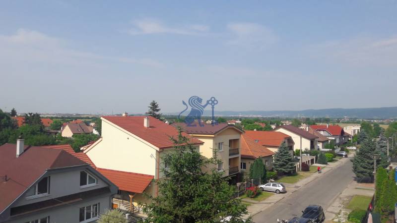 A view of terraced houses with red roofs on Školská Street in Chorvátsky Grob.