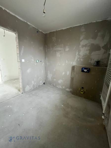 Empty rooms in a 3-room apartment with installation for a bathroom under renovation.