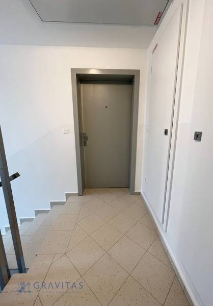 Entrance door with staircase and tiled floor in a 3-room apartment.