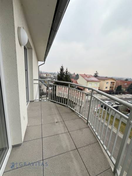 A balcony with a tiled floor and a view of Školská Street in Chorvátsky Grob.