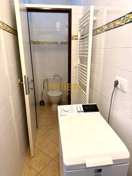 A bathroom with a washing machine and a separate toilet in a 2-room apartment.