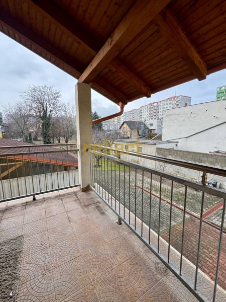 A balcony with tiles and a view of the surroundings in Bratislava - Ružinov on Oriešková Street.
