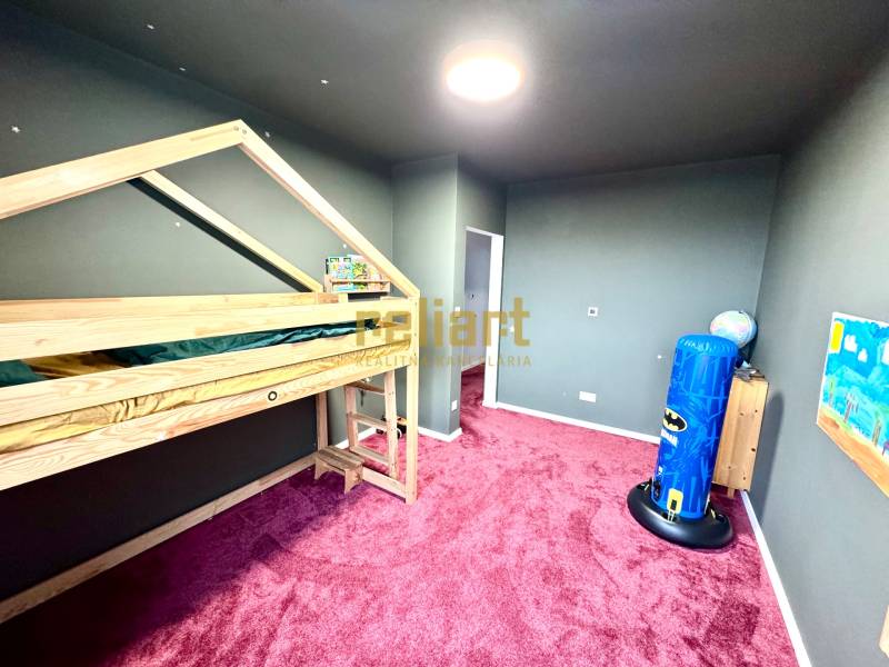 Children's room in a family house with a wooden decor floor and a bunk bed.