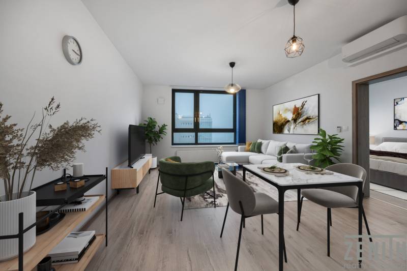 Living room with a sofa and a dining table in a two-room apartment, floor with wooden decor.