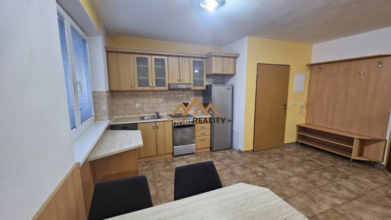 A kitchen in a 3-room apartment with wooden decor and ceramic tiles.