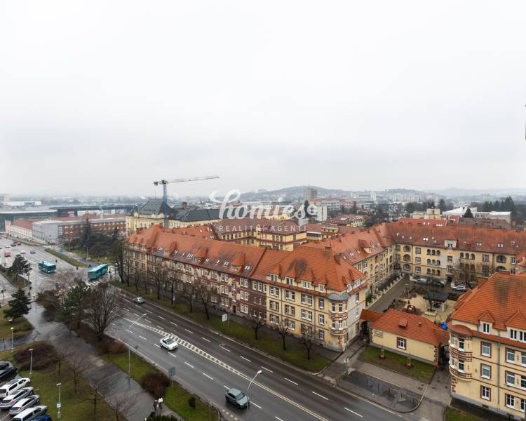 A view of historic buildings on Štúrova Street in Nitra with traffic.