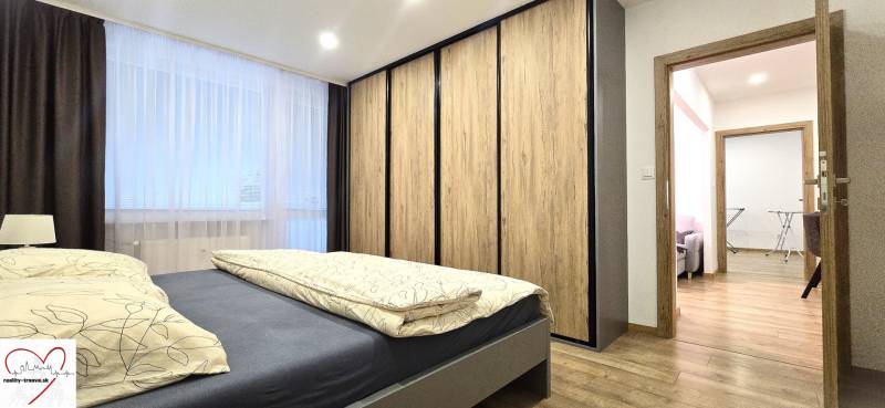 Bedroom with access to the living area, wood-decor flooring, 3-room apartment.