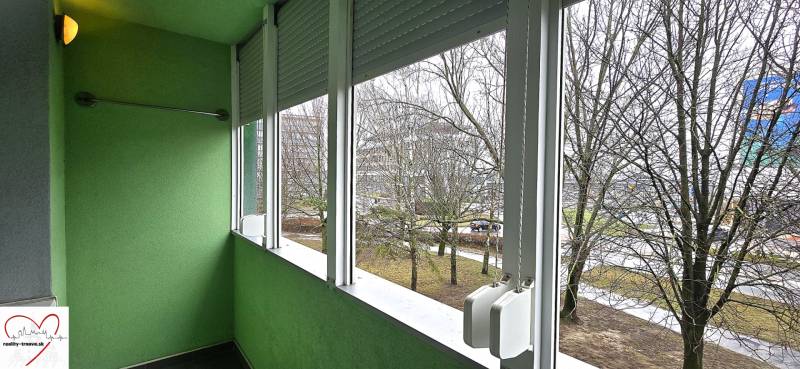 A glazed loggia with a view of the trees from a 3-room apartment on Golianova Street in Trnava.
