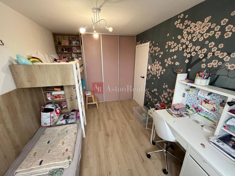 Children's room with a bunk bed, a desk, and a floor with a wooden decor in a 4-room apartment.