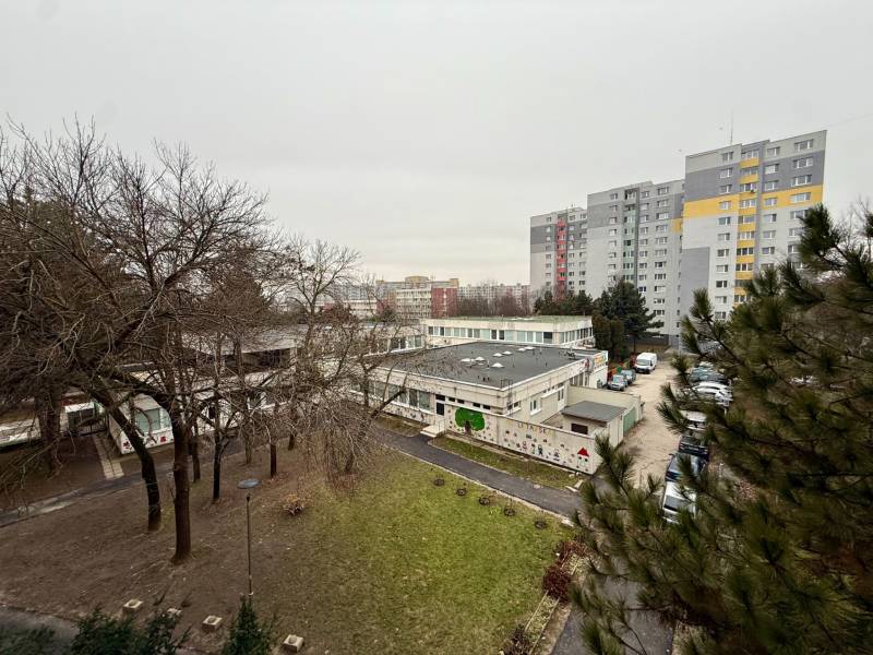 View of the Bratislava - Lúky housing estate, surrounded by greenery and apartment buildings.