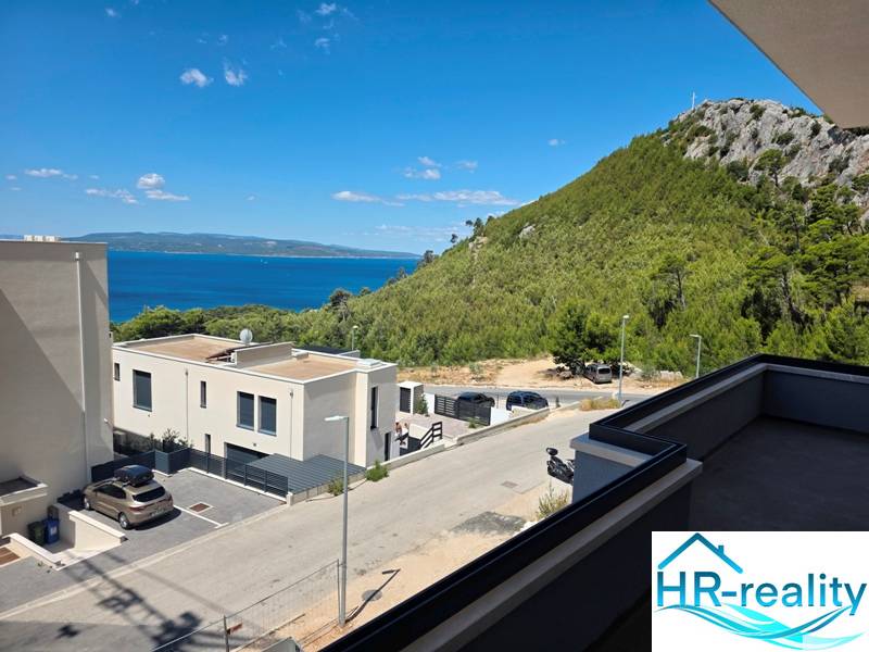 View from a holiday apartment in Makarska of the sea and green hills.