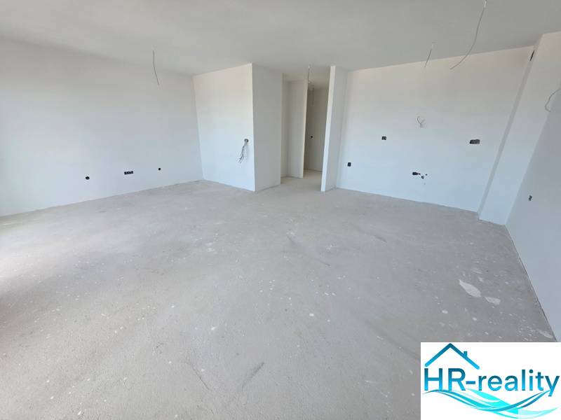 Living space of a holiday apartment with white walls under construction.