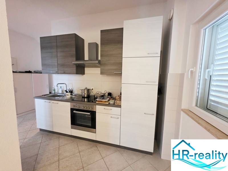A kitchen with combined cabinets and built-in appliances in a Holiday Apartment.
