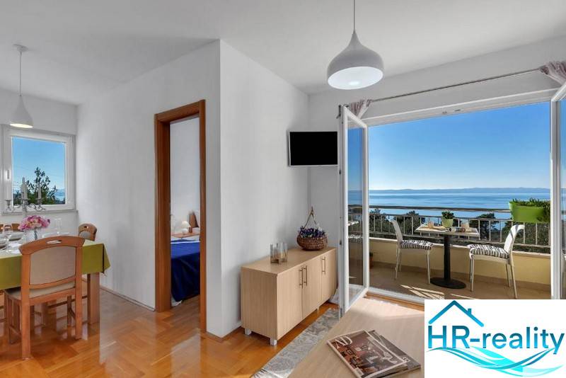 Interior of a 3-room apartment with a sea view, floor with wood decor.
