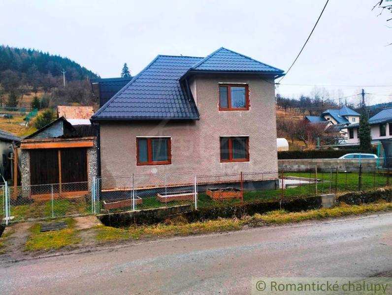 A family house in Jasenica with a new roof and a garden, surrounded by rural landscape.