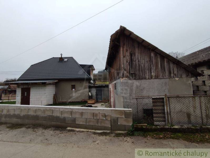 A family house with a wooden extension in Jasenica, surrounded by a fence and a block wall.