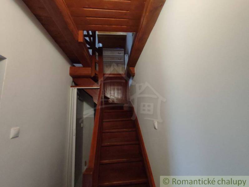A wooden staircase in a family house leading to the upper floor.