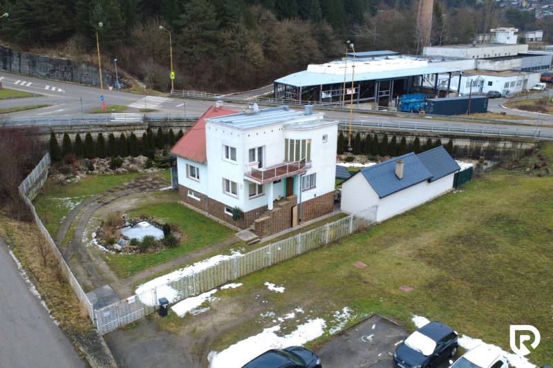 A family house on SNP Street in Považská Bystrica with a landscaped garden and driveway.