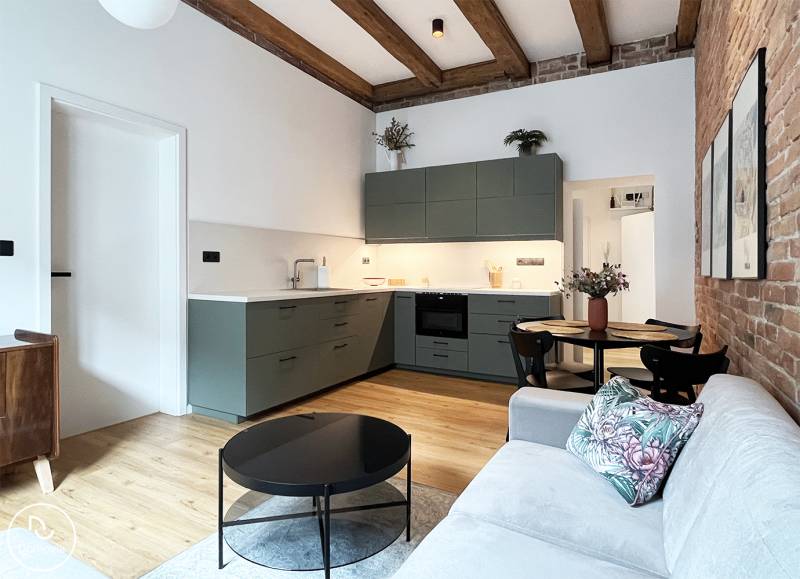 Cozy 2-room apartment with an open kitchen on Vajnorská Street, wooden beams, brick wall.