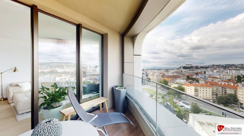 A view of Bratislava from a private terrace in a 3-room apartment, with comfortable seating.