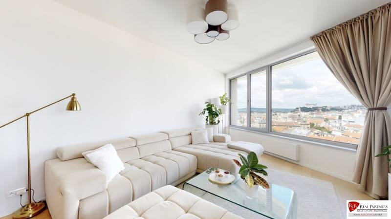 Bright living room in a 3-room apartment with a sofa and a view of Bratislava - Old Town.