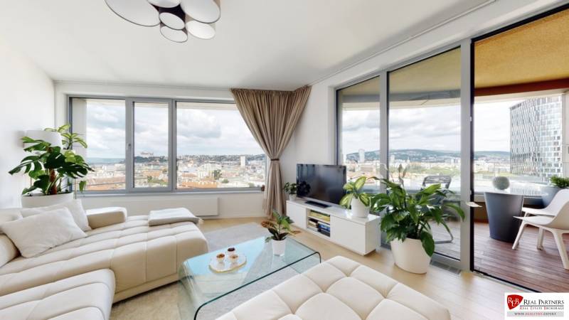 Living room in a 3-room apartment with large windows, view of Bratislava - Old Town.