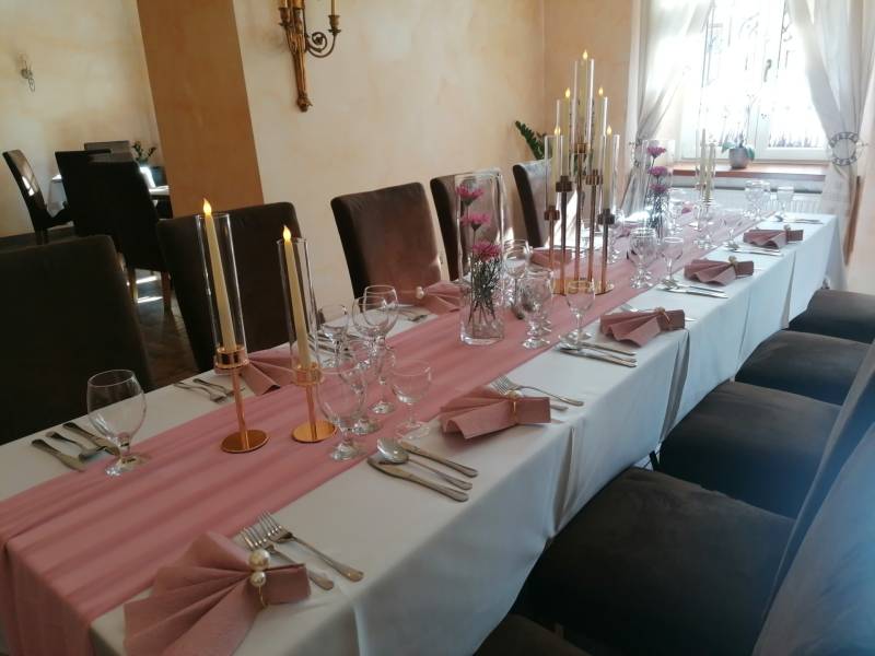 A stylish interior with a table for guests in hotels and guesthouses, decorated with candles and flowers.