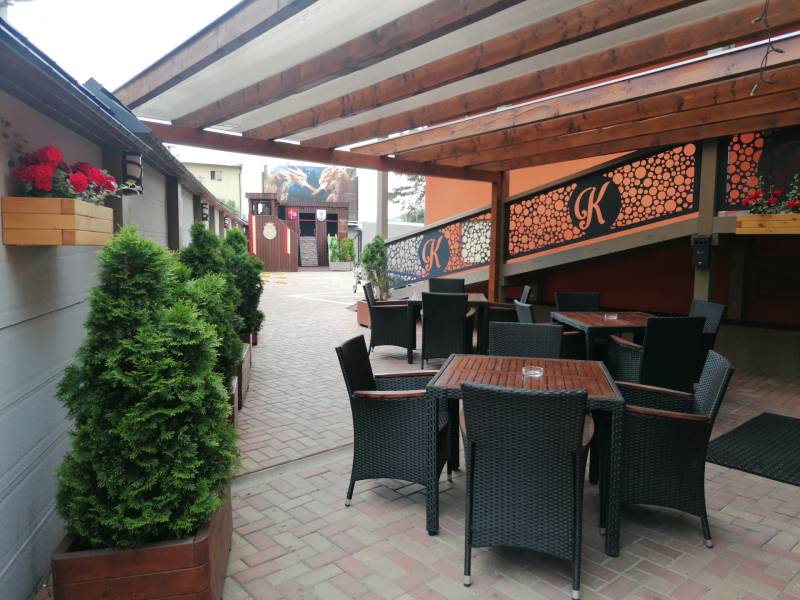 Outside in Poprad, hotels and guesthouses, terrace with rattan furniture and decorations.