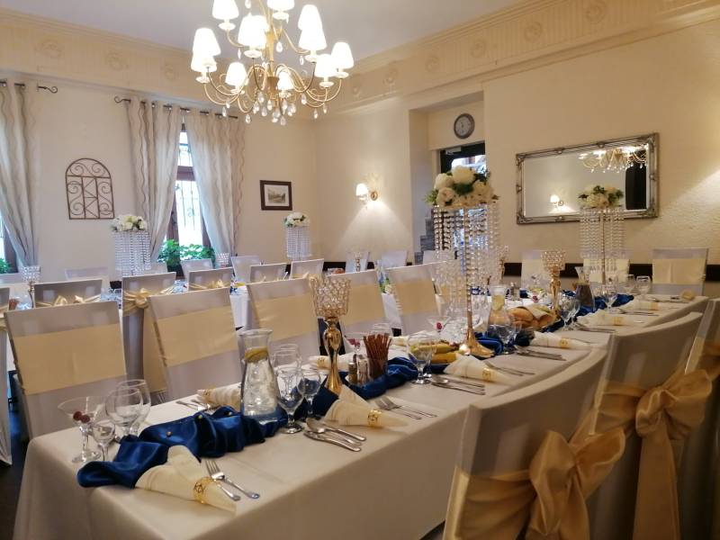 Wedding decoration in the interior of the hotel restaurant, elegantly set tables with floral arrangements.